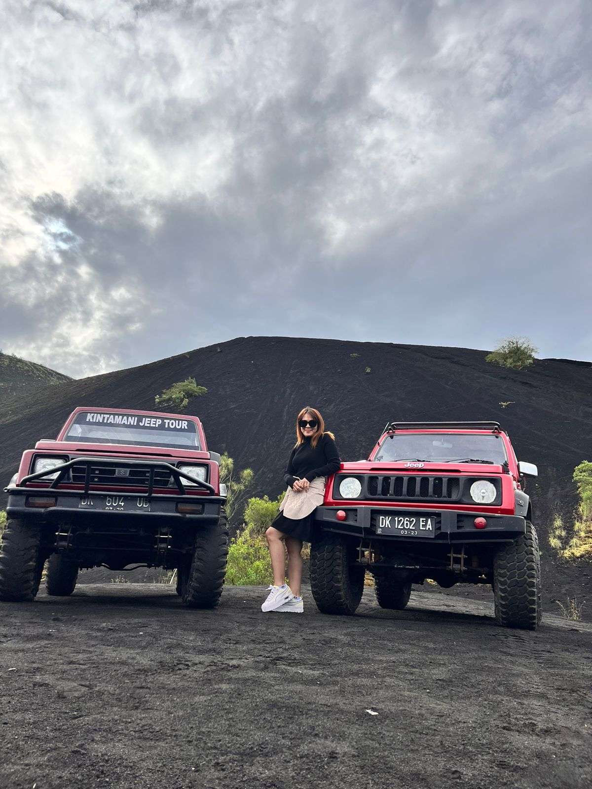 Two red Jeeps at the foot of Mount Batur