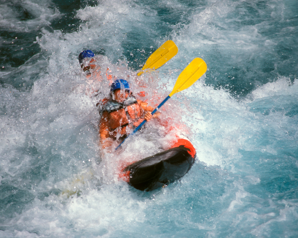 Travelers rafting through white water in Ubud