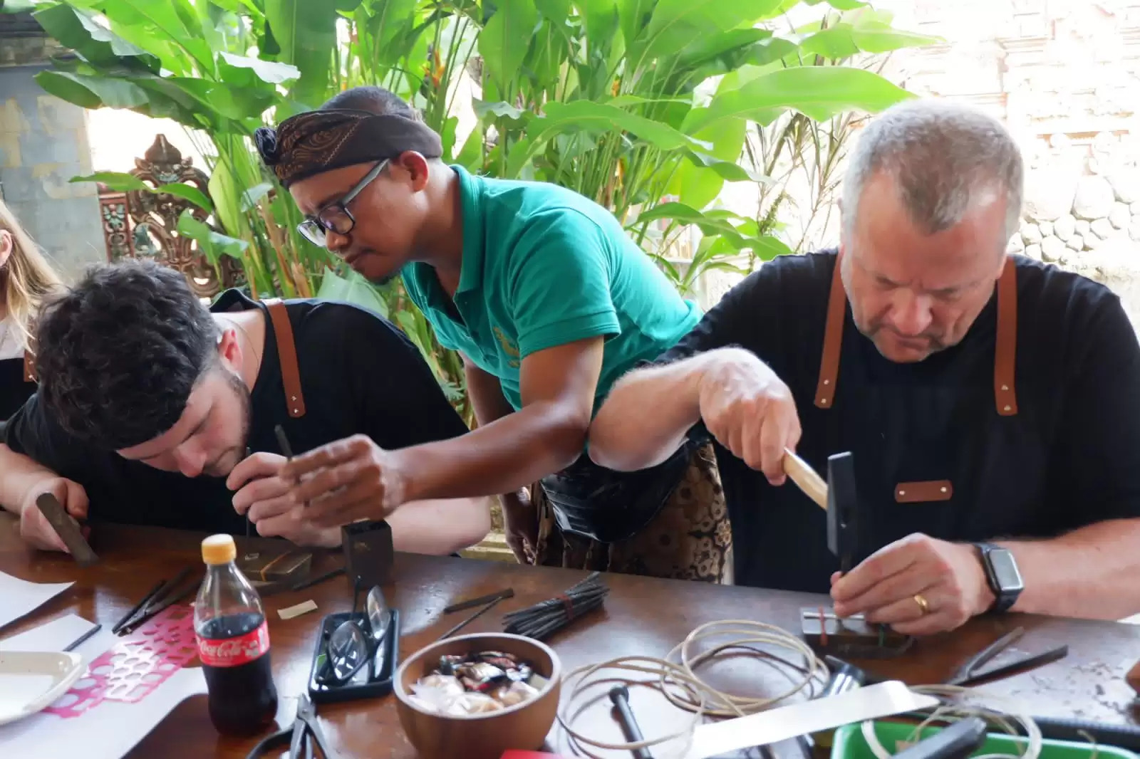 Participants making silver jewelry at a workshop