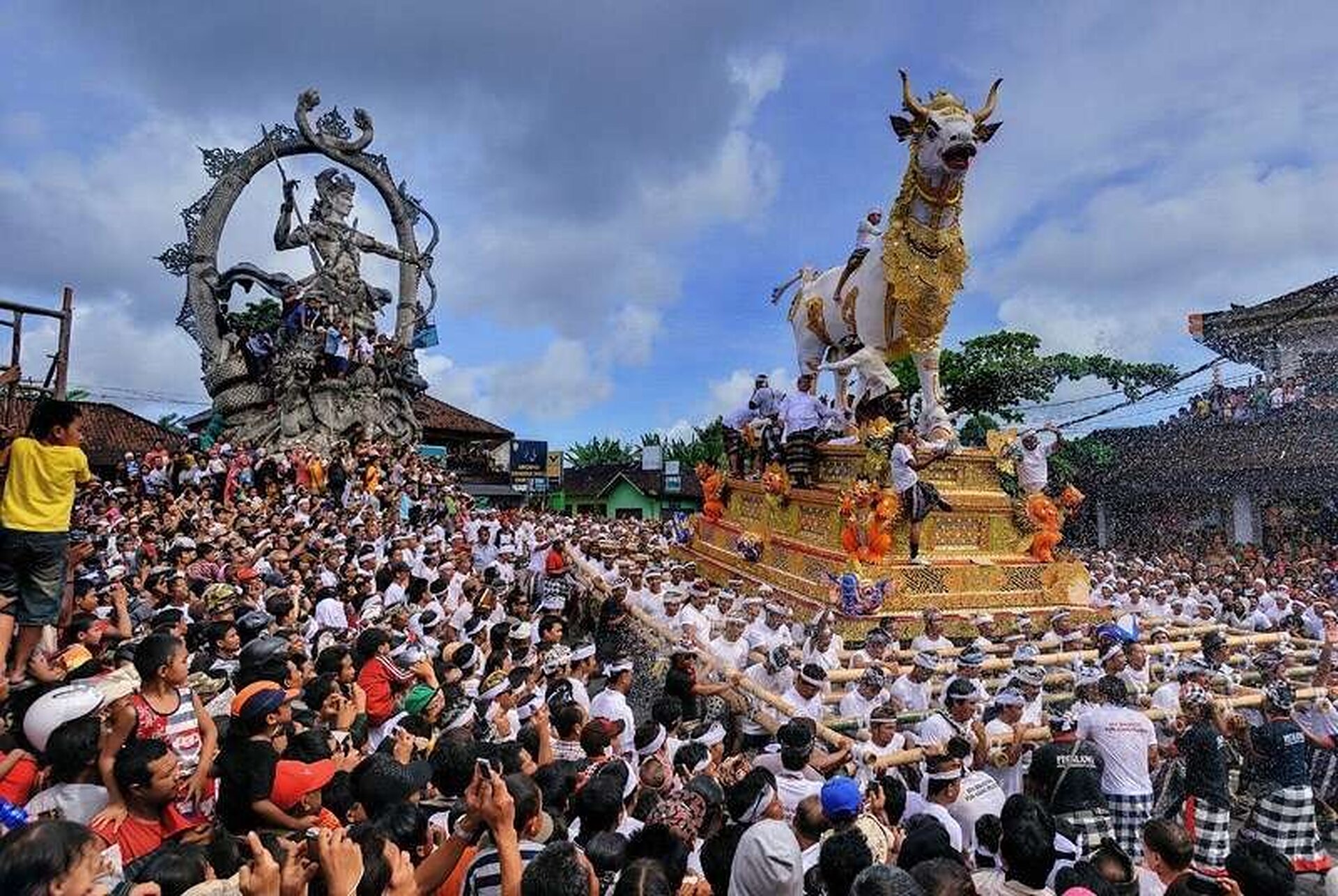 Balinese cremation ceremony procession with decorated ritual structures