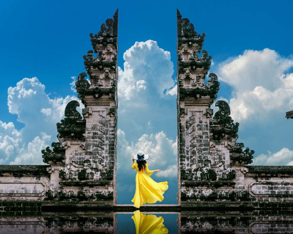 Balinese temple gates under a bright blue sky